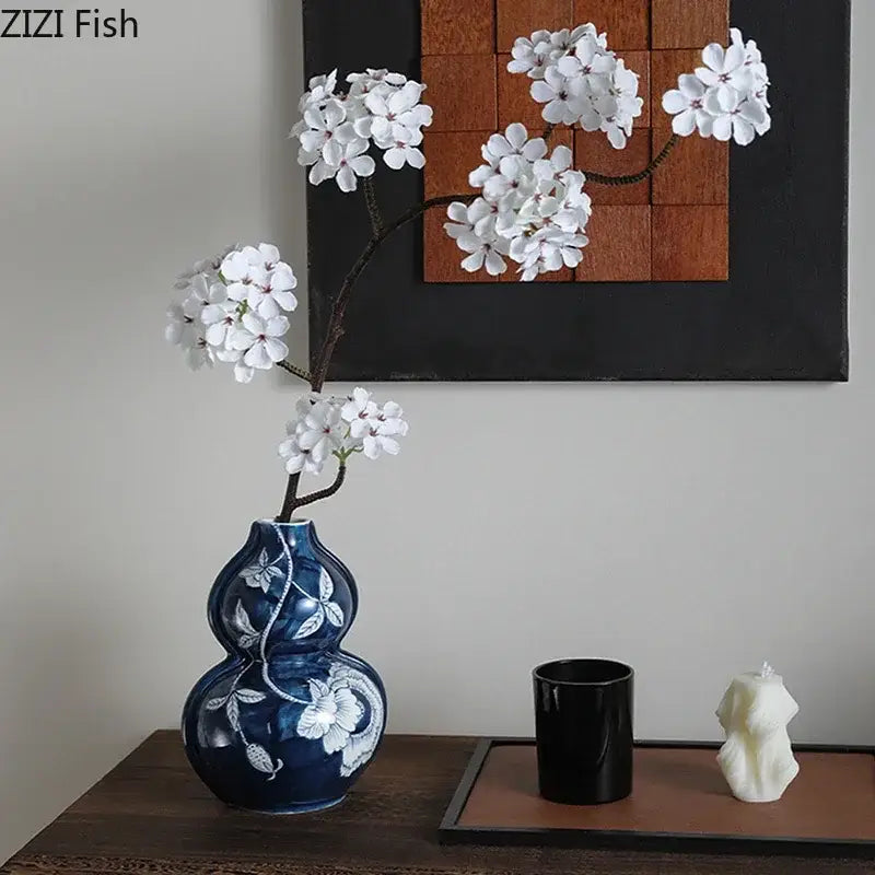 Classic blue porcelain vase shaped like traditional gourd with white floral vine patterns for living room decorbites blue porcelain