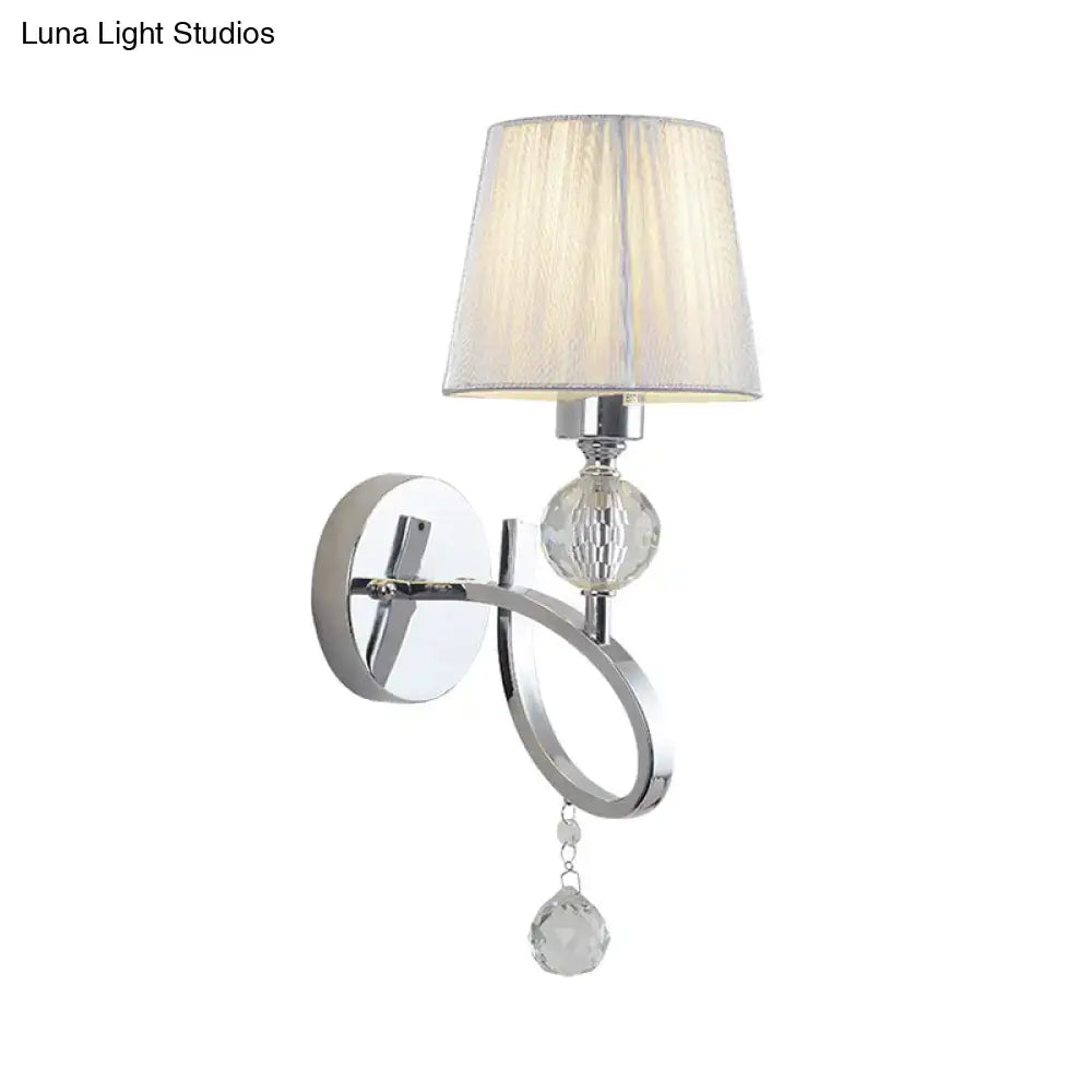 Classic chrome wall lamp with faceted crystal drop orb and off-white pleated fabric shade for bedroom sconce lighting