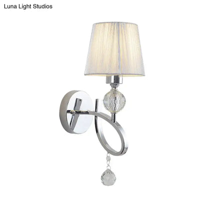 Classic chrome wall lamp with faceted crystal drop orb and off-white pleated fabric shade for bedroom sconce lighting