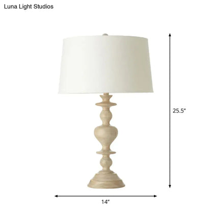 A cream-colored decorbites™ nightstand lamp with a white fabric shade and resin base suitable for 220v-240v use