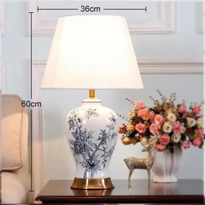 Classic white porcelain table lamp with blue floral hand-painted design and gold-toned base for living room decor