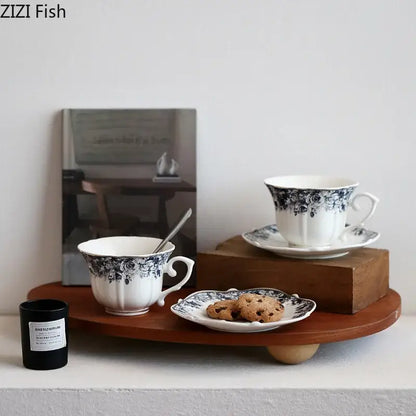 Classical grey blue rose ceramic cup with black floral detailing and fluted rim paired with matching saucer