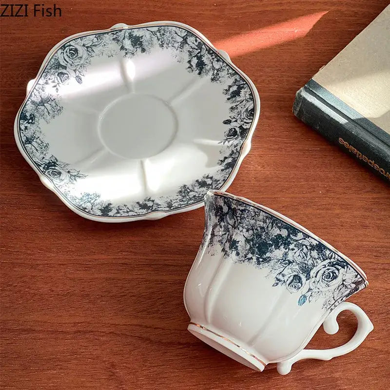 White ceramic cup and saucer set with delicate grey blue rose floral patterns for elegant dining room use