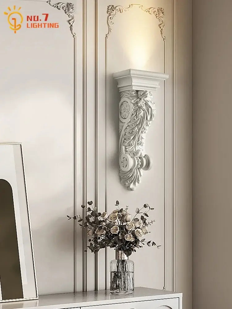White ornate cream resin wall lamp with intricate floral and scrollwork design decorbites cream resin wall decor