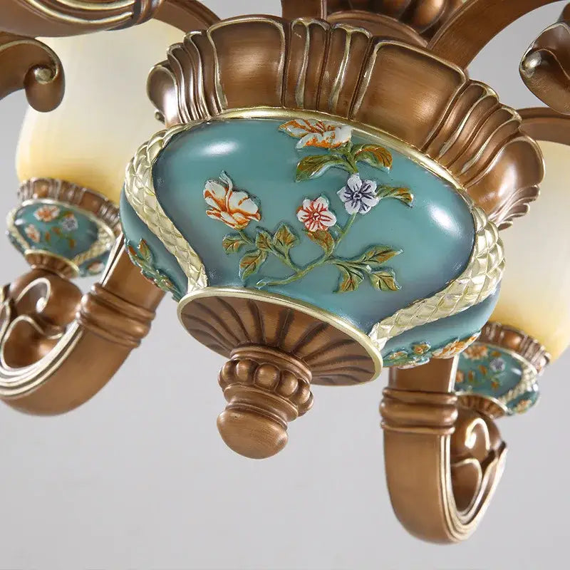 Classical resin chandelier bronze and turquoise with hand-painted floral motifs and gold-trimmed edges by decorbites classical
