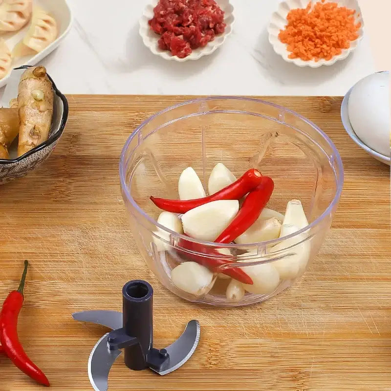 Clear 400ml mini food shredder with 3 blades and clear plastic bowl filled with garlic cloves and red chili peppers