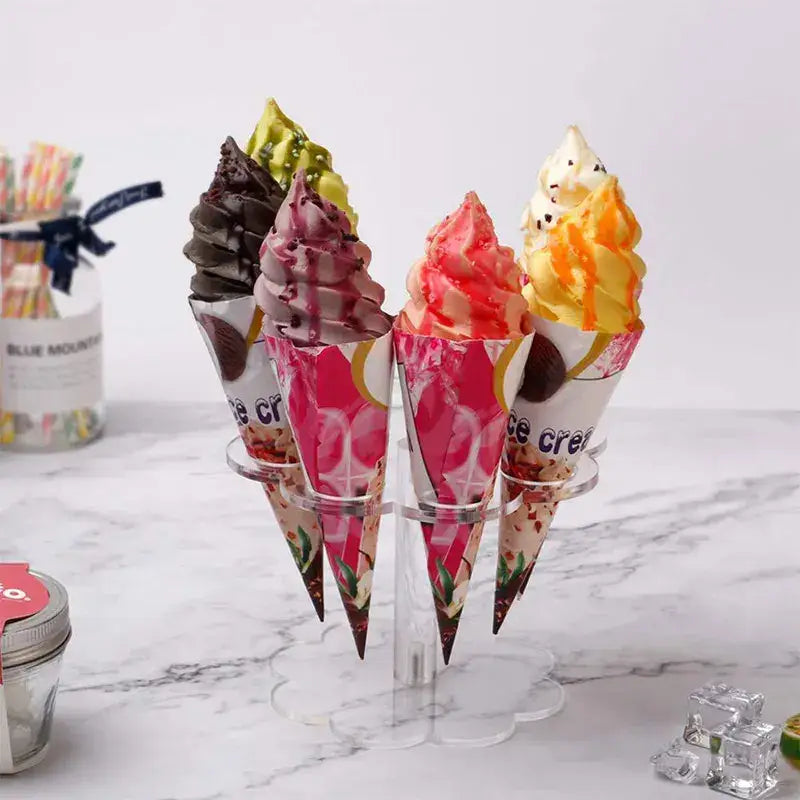 Clear acrylic cone holder stand displaying five colorful soft serve ice cream cones with assorted vibrant toppings