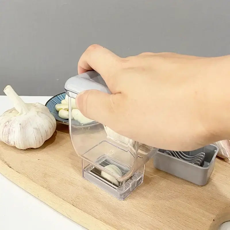 Clear plastic garlic grinding grater cutter with gray handle compact design for easy kitchen use by decorbites garlic grinding