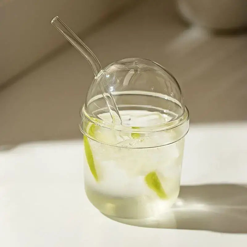 Clear glass bobo cup with ribbed lid and straw filled with ice and lime slices for kitchen milkshake decorbites clear glass