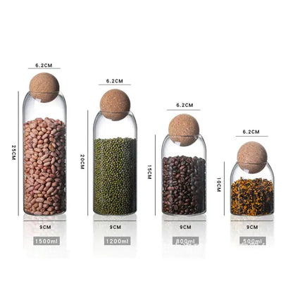 Set of four clear glass bottle dispenser jars with cork stoppers labeled with capacity for kitchen storage use