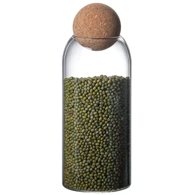 Clear glass bottle dispenser with cork stopper filled with green mung beans from decorbites glass bottle dispenser set