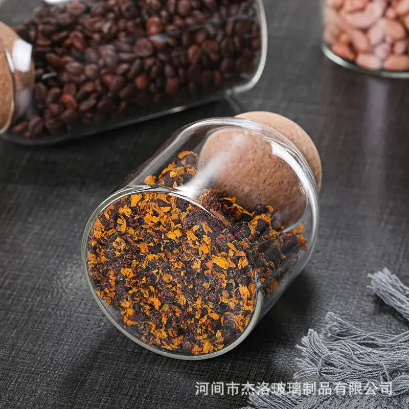 Clear glass bottle dispenser set with cork stoppers filled with dried orange and brown flower petals for decorbites glass bottle decor