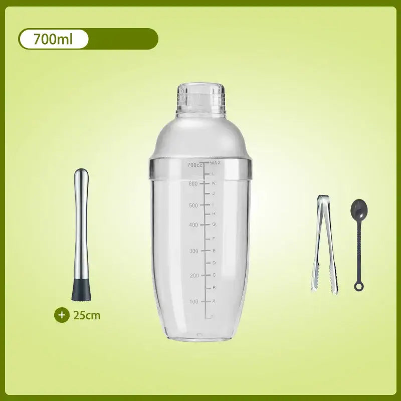 Clear glass cocktail shaker with silver lid and measurement markings, includes muddler, ice tongs, and bar spoon for beverage mixer