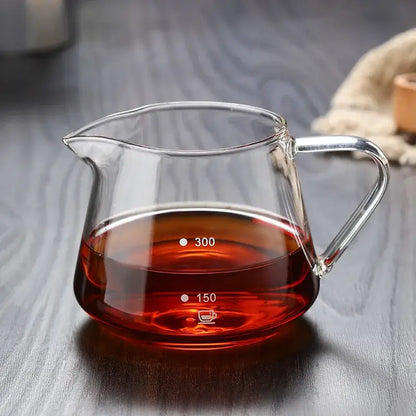 Clear glass coffee pot with measurement markings filled with rich amber liquid for precise kitchen use