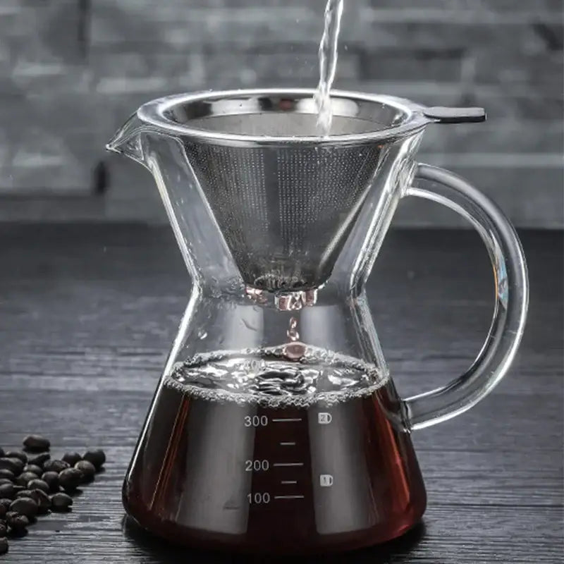 Clear glass coffee pot with stainless steel filter and measurement markings for precise brewing use