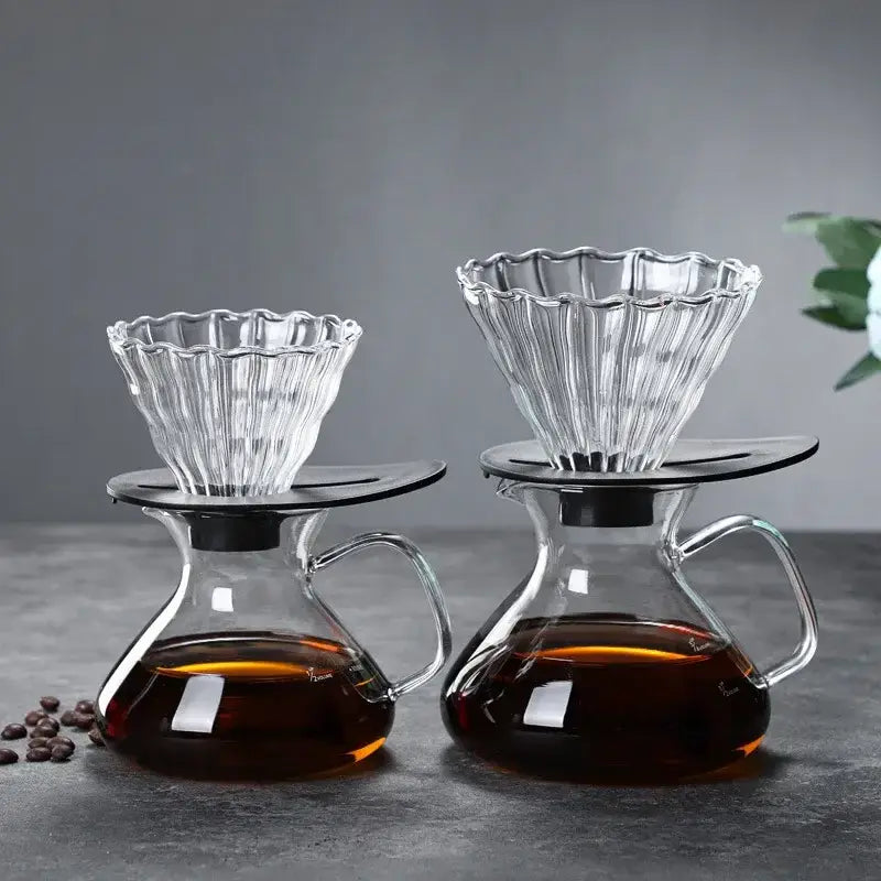 Clear glass drip pot coffee set with fluted glass drippers and black bases atop glass carafes filled with brewed coffee