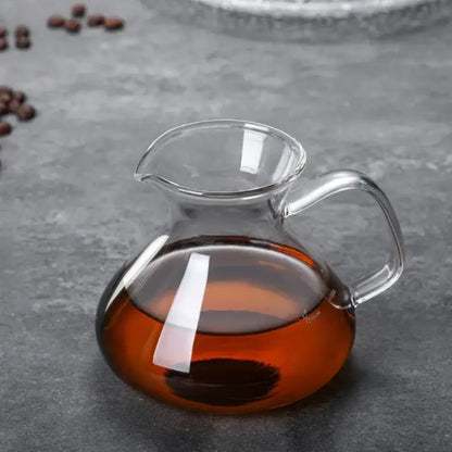 Clear glass drip pot coffee set with amber liquid in a glass kitchen carafe with filter for drip pot coffee use