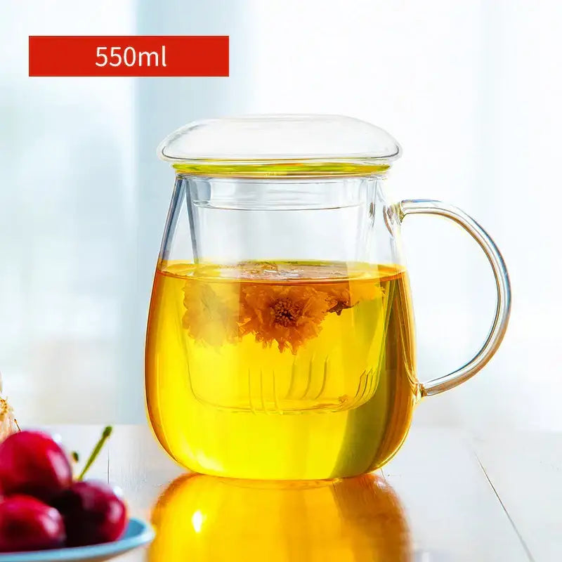 550ml clear glass floral tea pot with matching lid and handle containing golden-yellow tea with orange petals