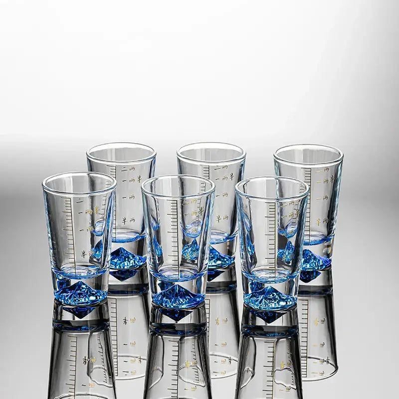 Clear glass liquor cup set with gold measurement markings and blue crystal-like bases by decorbites clear glass