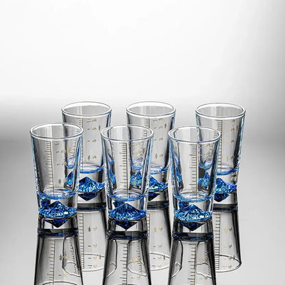 Clear glass liquor cup set with blue crystal-like bases and gold measurement markings for decorbites clear glass