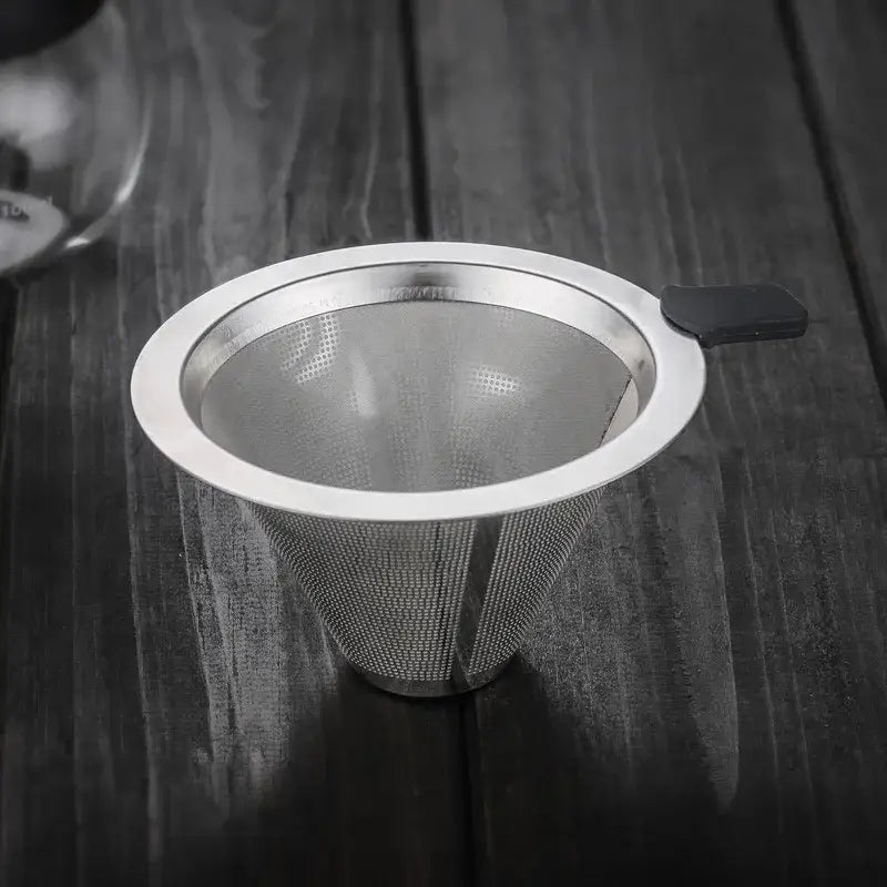 A sleek stainless steel filter tea infuser with black handle designed for use with clear glass pour over coffee maker