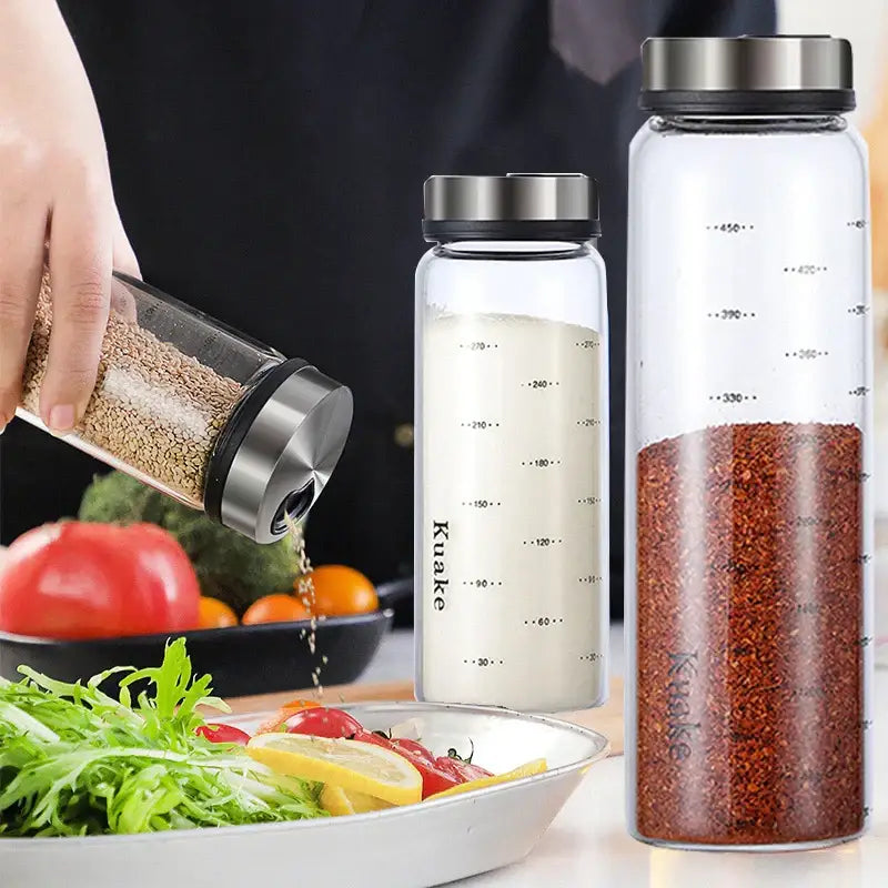 Clear glass spice shakers with rotary stainless steel lid by kuake filled with salt and red pepper flakes for kitchen storage