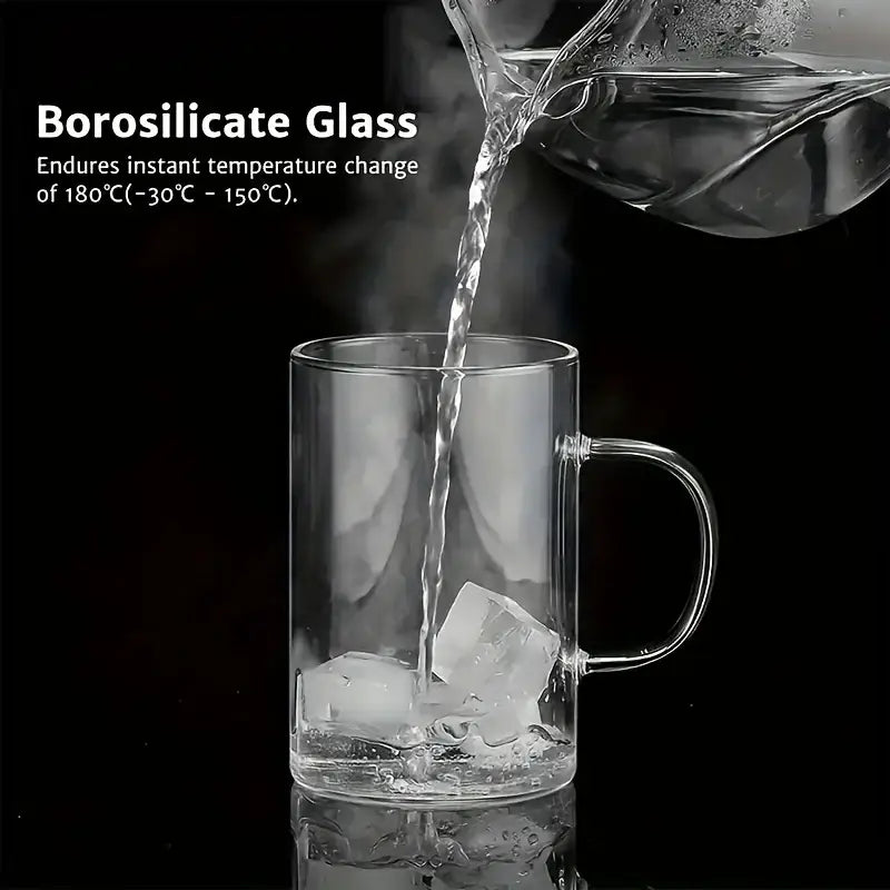 Clear borosilicate glass tea infuser mug with handle filled with ice being poured into featuring stainless steel infuser