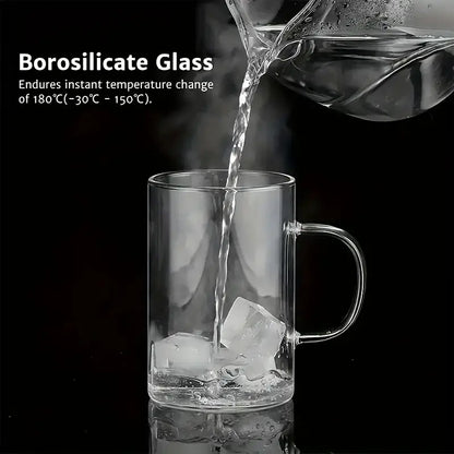 Clear borosilicate glass tea infuser mug with handle filled with ice being poured into featuring stainless steel infuser