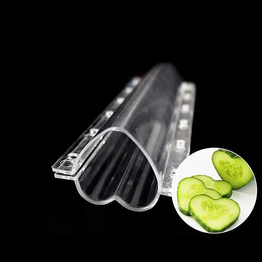 Clear plastic heart shaped vegetable growth mold with ridged interior and circular cutouts for kitchen vegetable growth