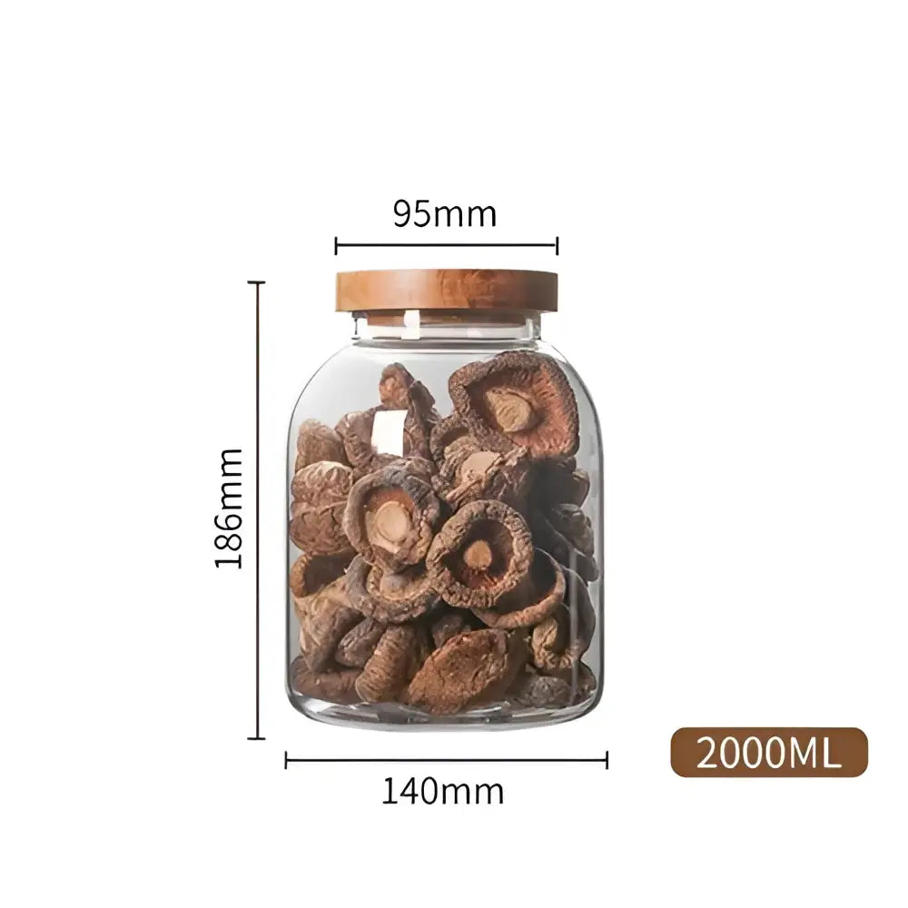 Clear kitchen glass jar with acacia wooden lid filled with dried mushrooms for food storage use