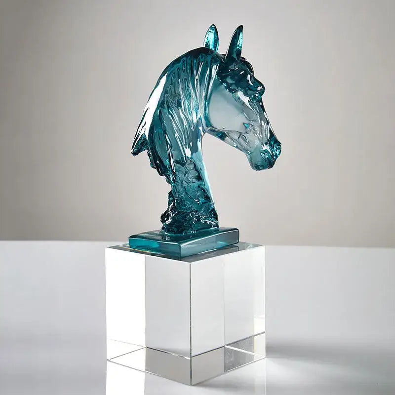 A translucent teal glass horse head crystal sculpture with flowing mane on a clear base for living room decorbites horse head decor
