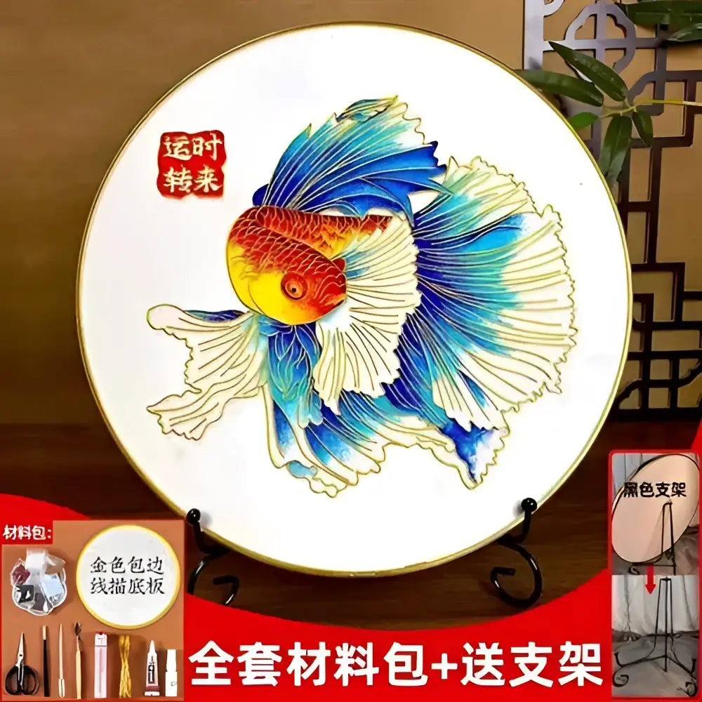 A white ceramic plate with a hand-painted goldfish design and ornate golden rim from Decorbites cloisonne silk enamel diy kit
