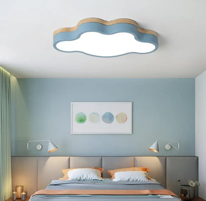Cloud led baby chandelier with soft blue body, wooden trim, and bright white illumination for sage green and pink decorbites room