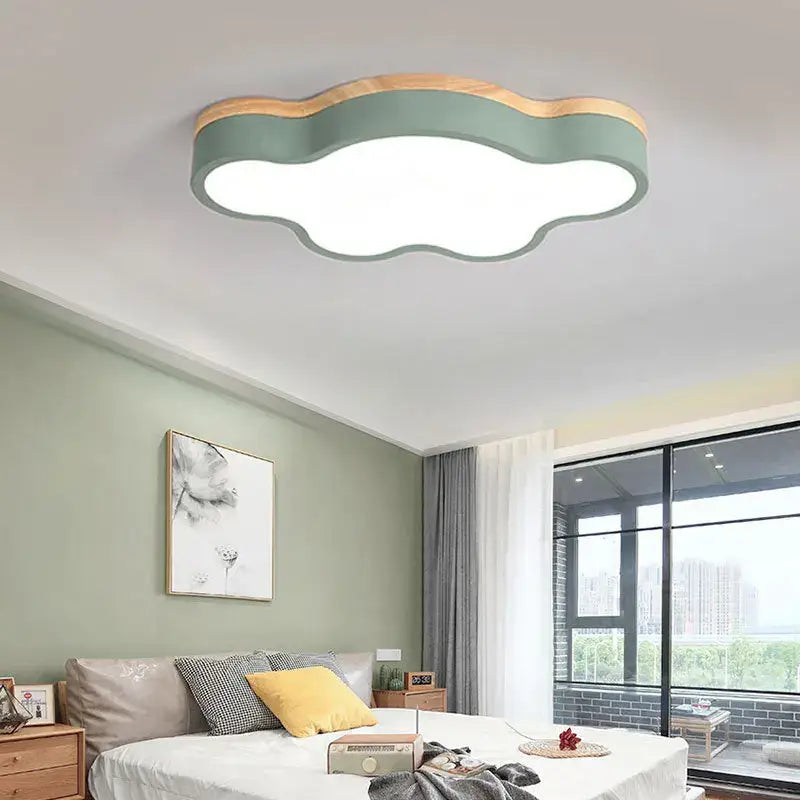 Cloud led baby chandelier with soft sage green body, natural wood trim, and illuminated white center for nursery decorbites cloud led