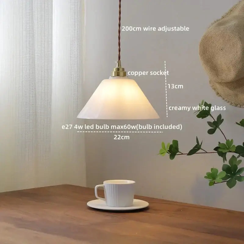 A warm creamy white ceramic led pendant light with brass copper socket from decorbites for dining room decor