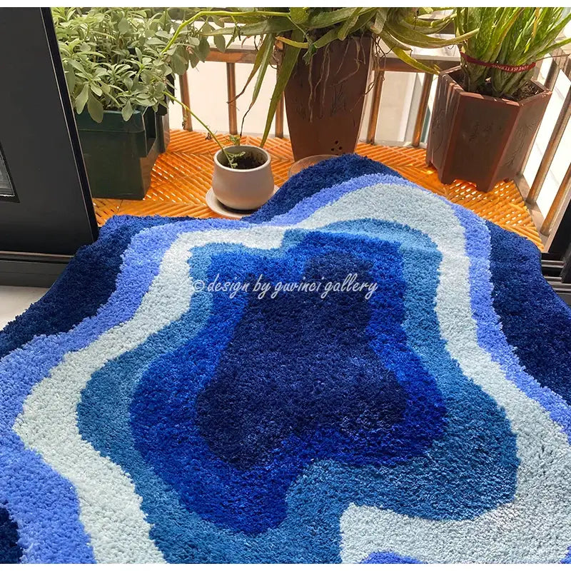 A plush shaggy bath mat with concentric blues and white rings resembling a geode decorbites cloudy blues wavy retro rug