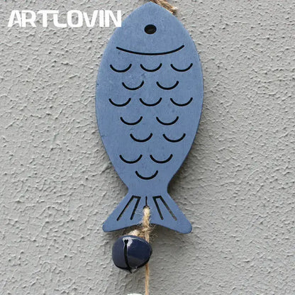Coastal blue and white drift wood bells featuring a blue wooden fish with black engraved scales and a dark blue bell