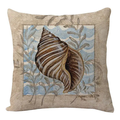 Beige decorbites coastal cushion with brown tan seashell illustration and gray seaweed on blue watercolor background