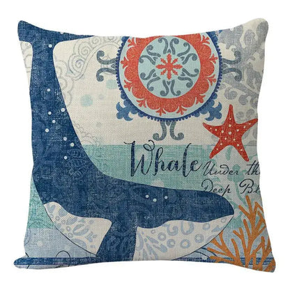 Square coastal cushion cover from decorbites featuring a navy blue whale with coral and starfish on textured fabric