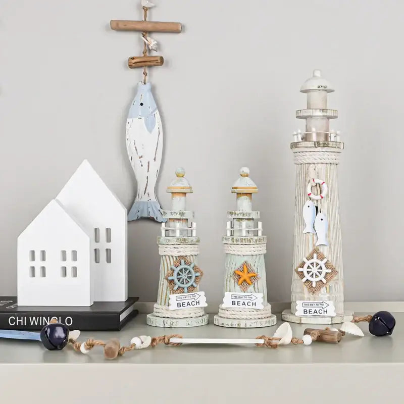 Coastal white and gray wooden ship model decor featuring a distressed coastal wooden lighthouse with nautical accents