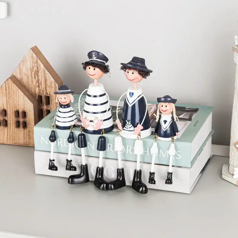 A charming family of four wooden figurines in nautical striped shirts for decorbites coastal wooden ship model decor