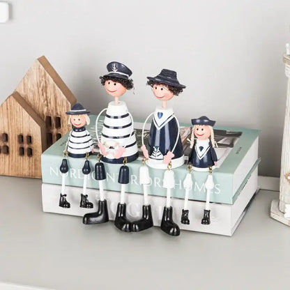 A charming family of four wooden figurines in nautical striped shirts for decorbites coastal wooden ship model decor