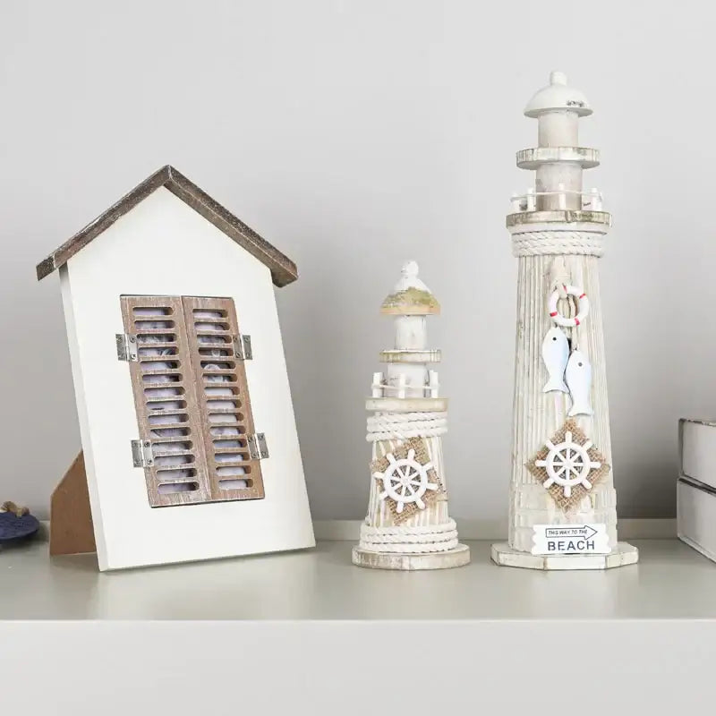 White painted coastal wooden lighthouse ornament with rope detailing and nautical decorbites coastal wooden ship model