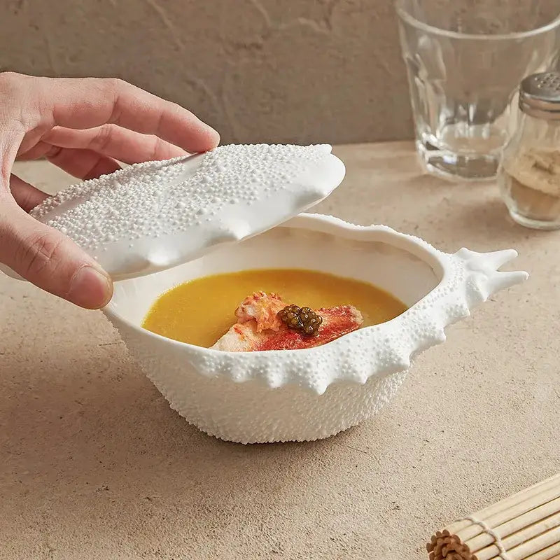 Coastal white ceramic soup bowl shaped like a shell with textured surface and matching lid for dining room decor
