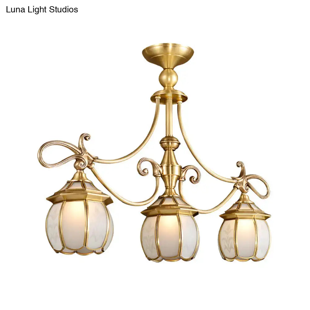 Brass-finished DecorBites colonial lantern island light fixture with three ornate frosted glass shades for dining room