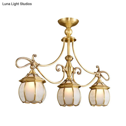 Brass-finished DecorBites colonial lantern island light fixture with three ornate frosted glass shades for dining room