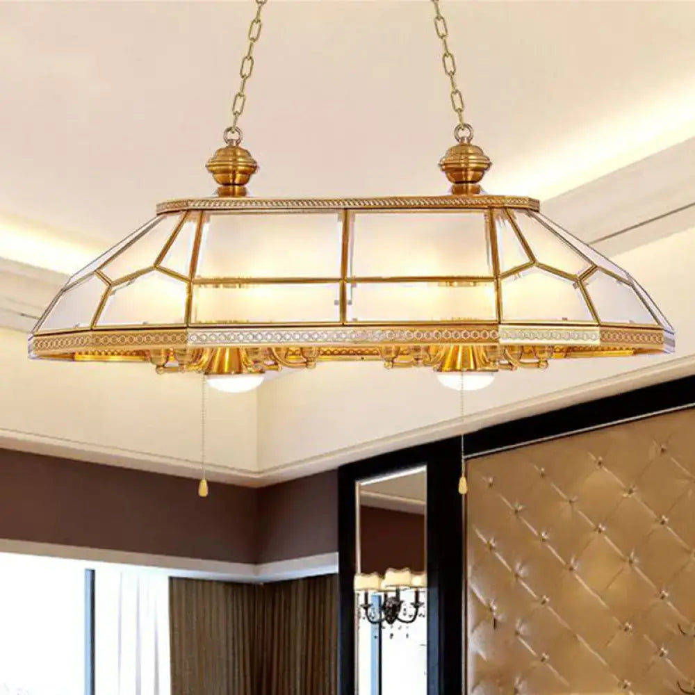 Gold-toned brass pendant light with geometric stained-glass and opal blown frosted glass panels for living room decor