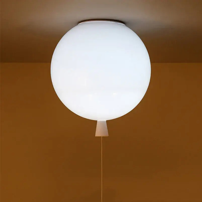 A sleek frosted white spherical ceiling sconce lamp with a minimalist design and subtle pull cord for bedroom decor