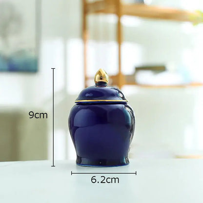 Deep blue ceramic storage jar with gold-toned lid and decorative finial for kitchen tea caddy use