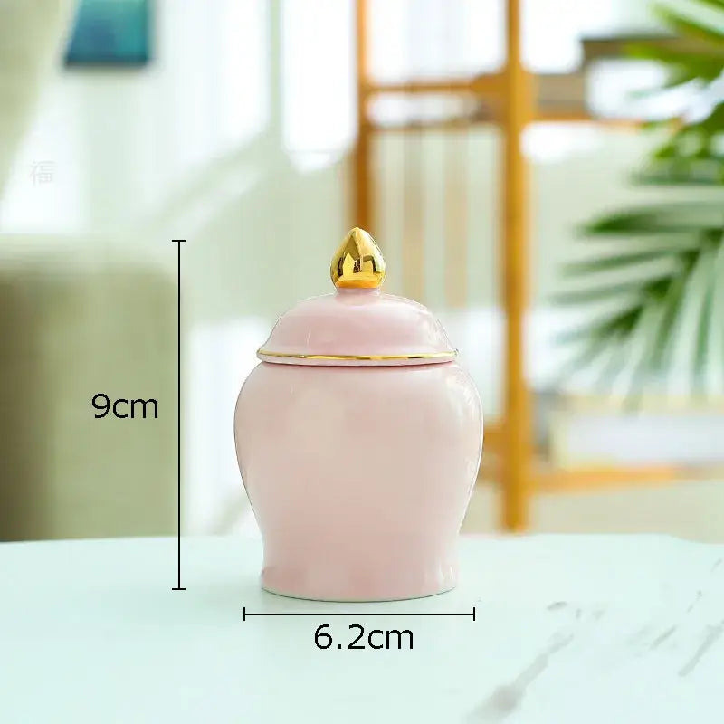 Delicate pink ceramic storage jar with gold lid and lotus finial ideal for kitchen tea caddy or ceramic storage
